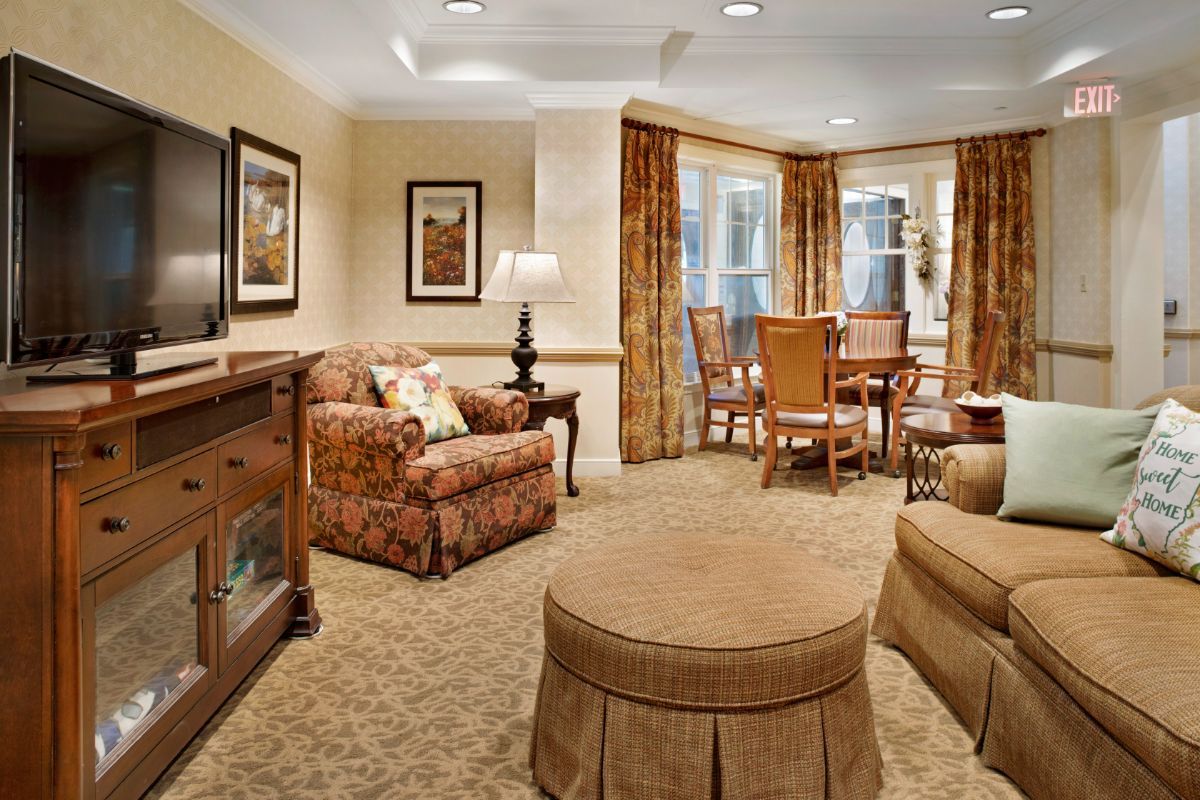 A cozy living room with classic furnishings and a dining area.