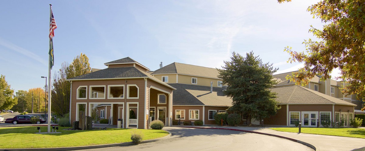 A hotel building with a clear blue sky in the background.