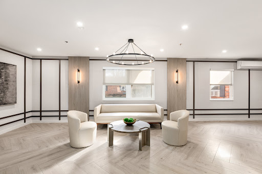 A modern lounge area featuring sleek furniture and contemporary lighting.