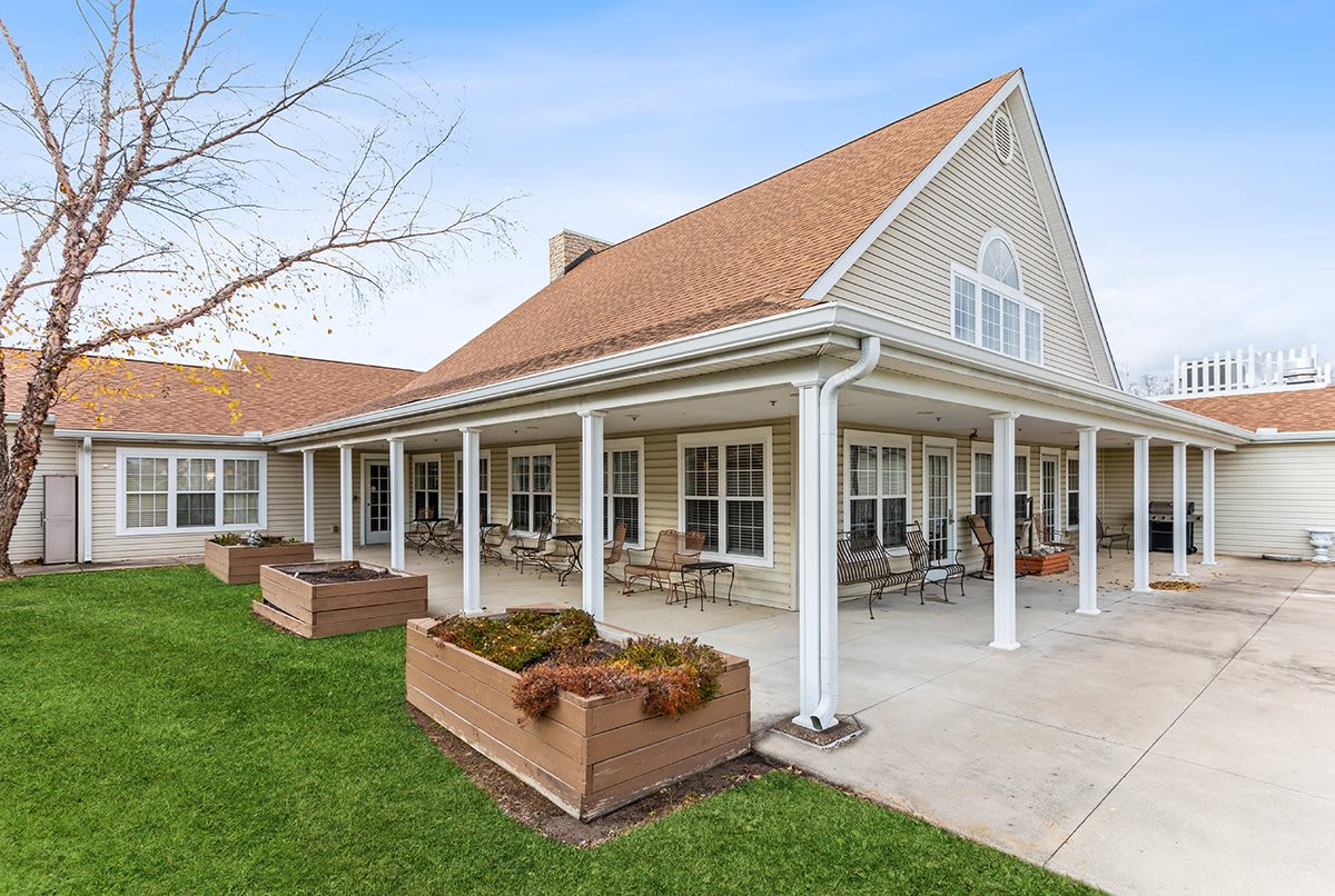 A single-story house with a spacious porch and well-maintained lawn.