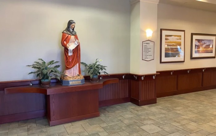 A religious statue in a decorated indoor setting.