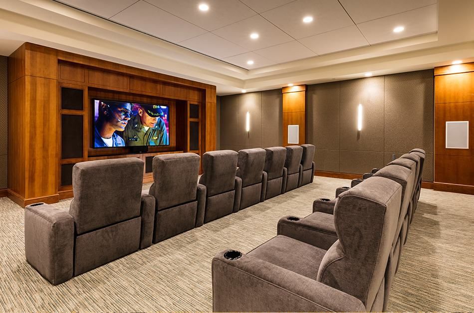 A cozy home theater setup with plush seating and a large screen.