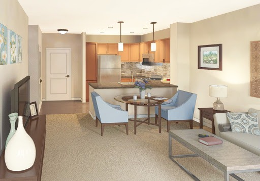 A cozy and modern living space featuring an open layout with a kitchen and comfortable seating.