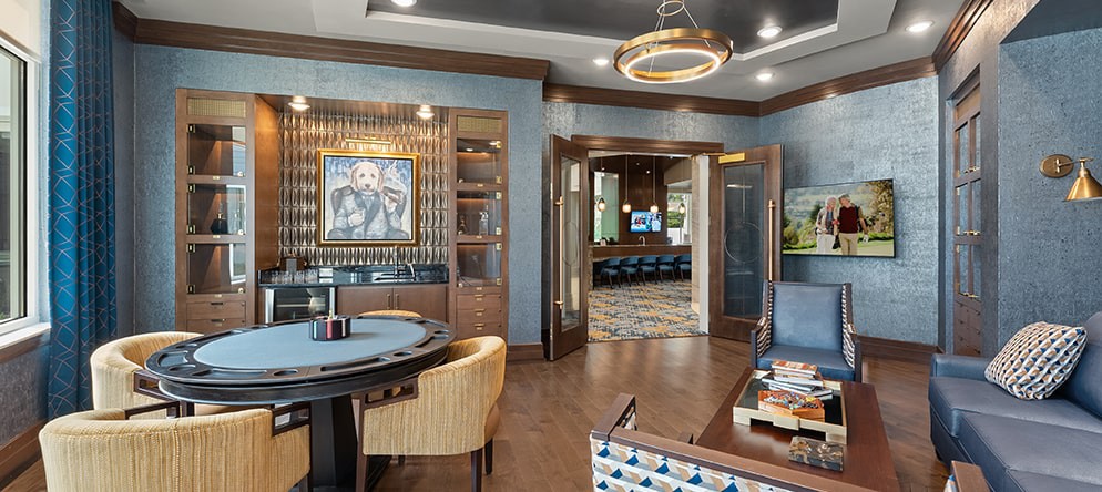 A luxurious game room with a poker table and modern decor.