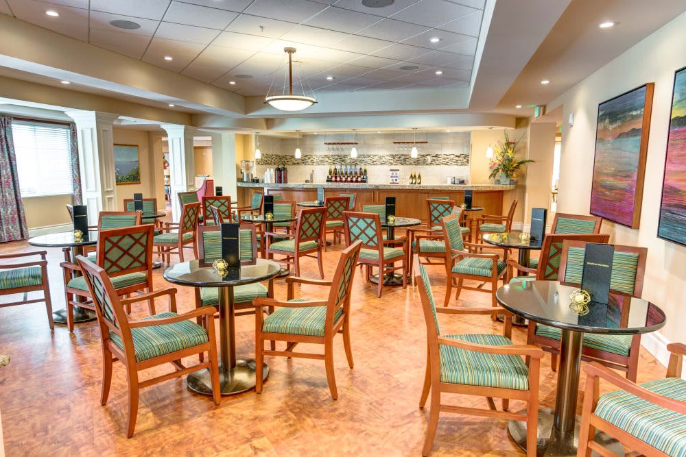 An empty restaurant dining area with neatly arranged tables and chairs.