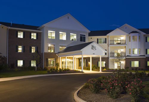 A well-lit residential building entrance at night.