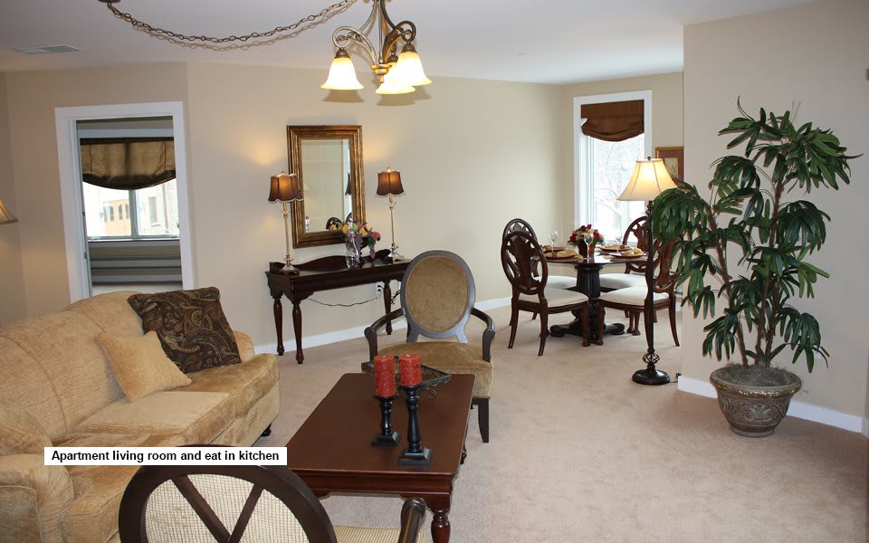 A cozy living room with elegant furniture and a dining area in the background.