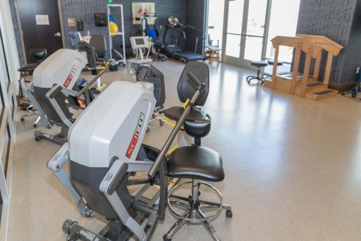 A modern rehabilitation center equipped with various exercise machines and therapy equipment.