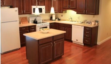 A modern kitchen with wooden cabinets and a central island.