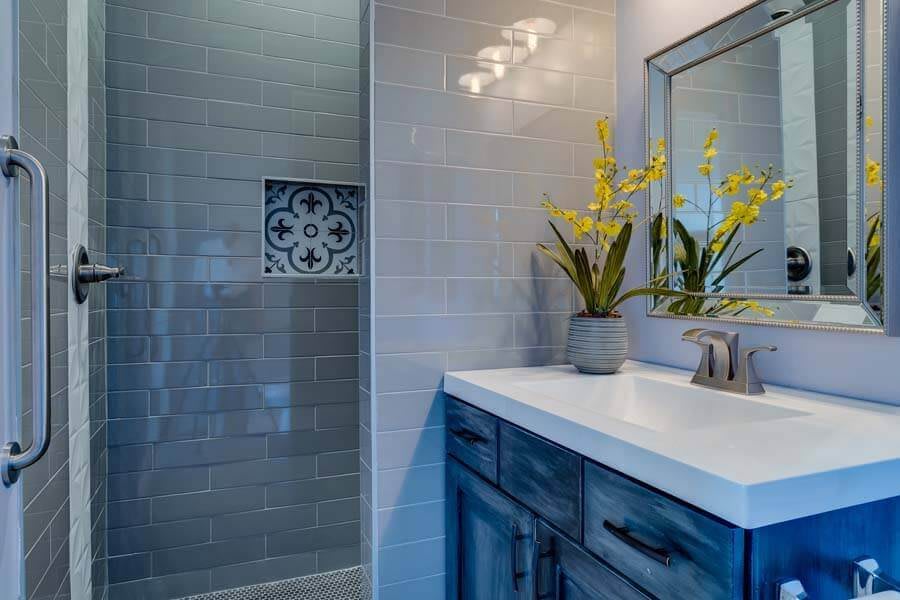 A modern bathroom with a sleek tile design and elegant vanity.