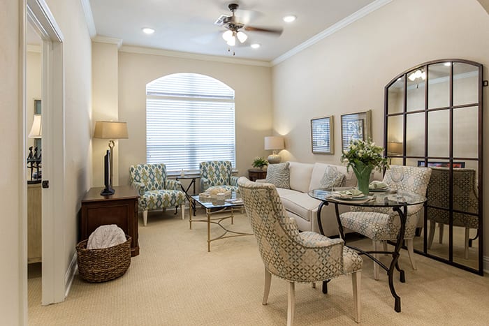 A cozy and elegantly decorated living room featuring comfortable seating and a warm ambiance.