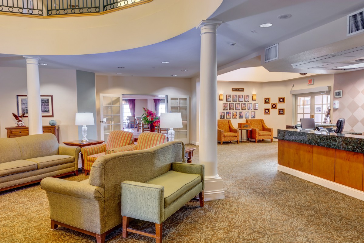 A cozy and well-furnished lobby with comfortable seating and a reception desk.
