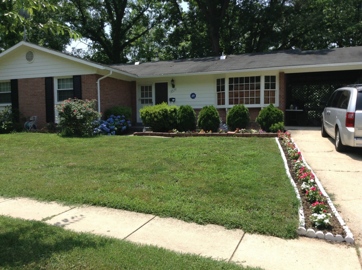 A suburban house with a well-maintained lawn and garden.