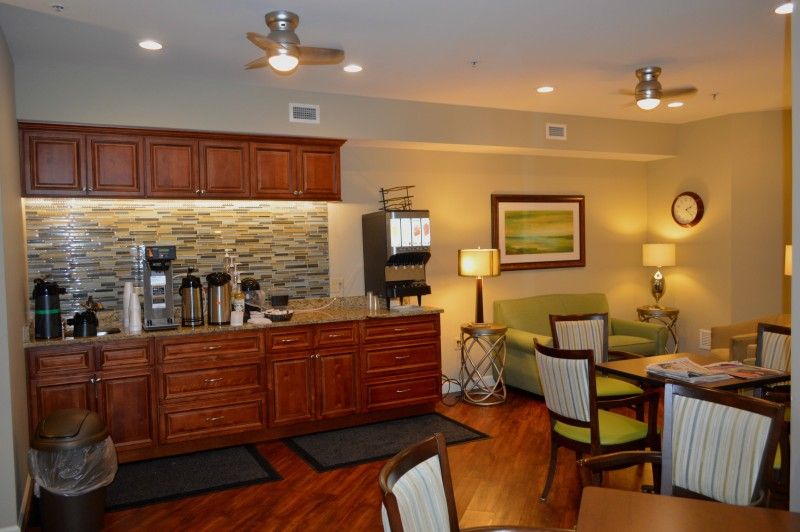 A cozy kitchenette with a coffee station and a small seating area.