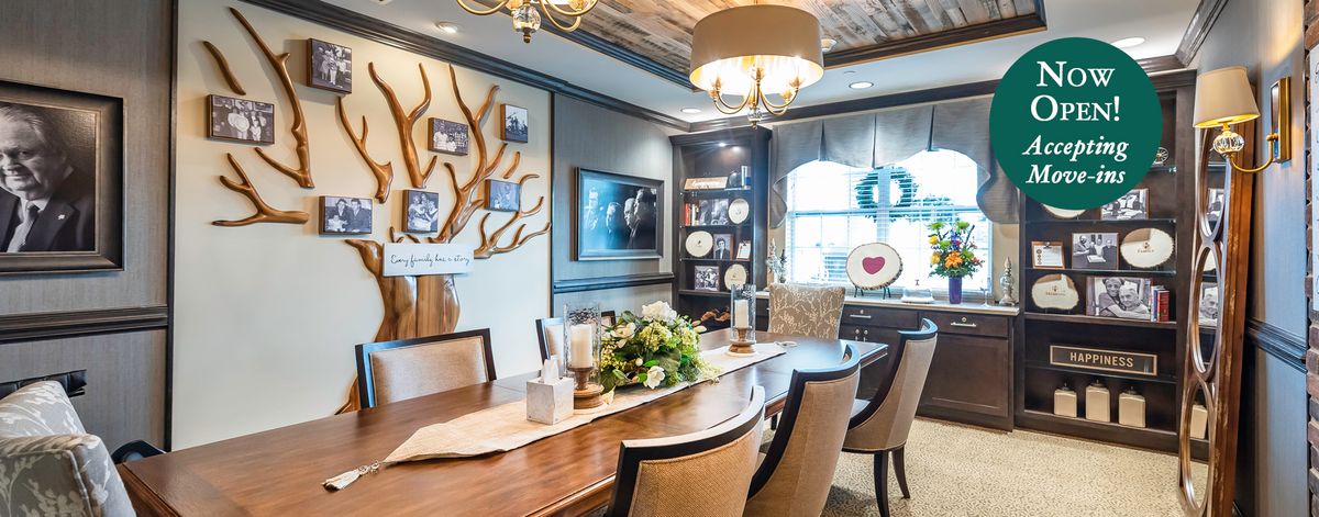 A beautifully decorated dining room with a large wooden table, elegant chairs, and stylish artwork on the walls.
