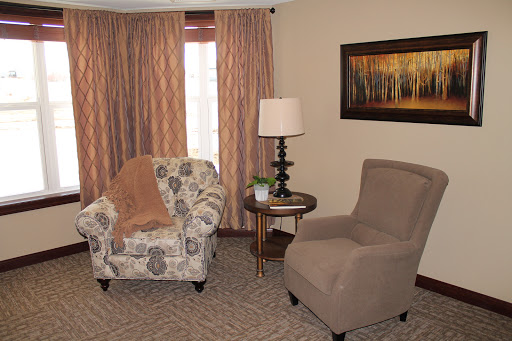 A cozy living room setup featuring comfortable seating, decorative curtains, and a warm ambiance.