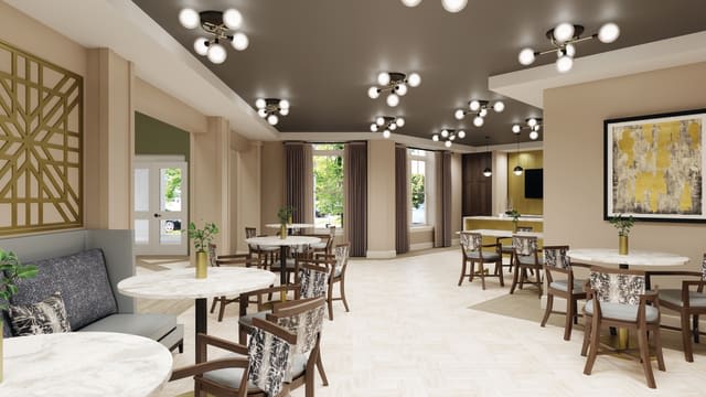 A modern restaurant interior featuring elegant tables, chairs, and stylish lighting fixtures.