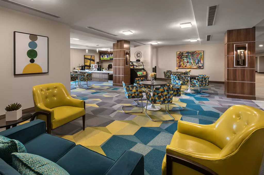 A modern lobby with colorful carpet and stylish seating arrangements.