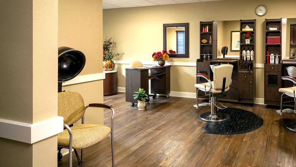 A well-organized salon interior featuring styling chairs, a mirror, and a hairdryer station.