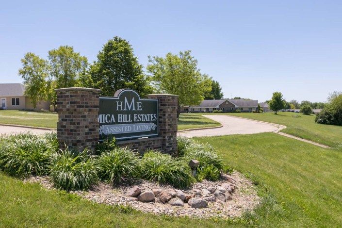 Entrance sign for Oak Hill Estates surrounded by well-maintained landscaping.