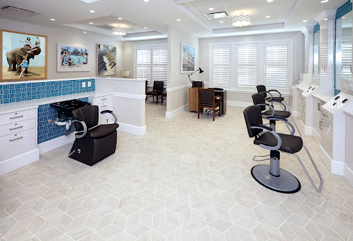A spacious and modern hair salon interior with stylish barber chairs and a welcoming atmosphere.