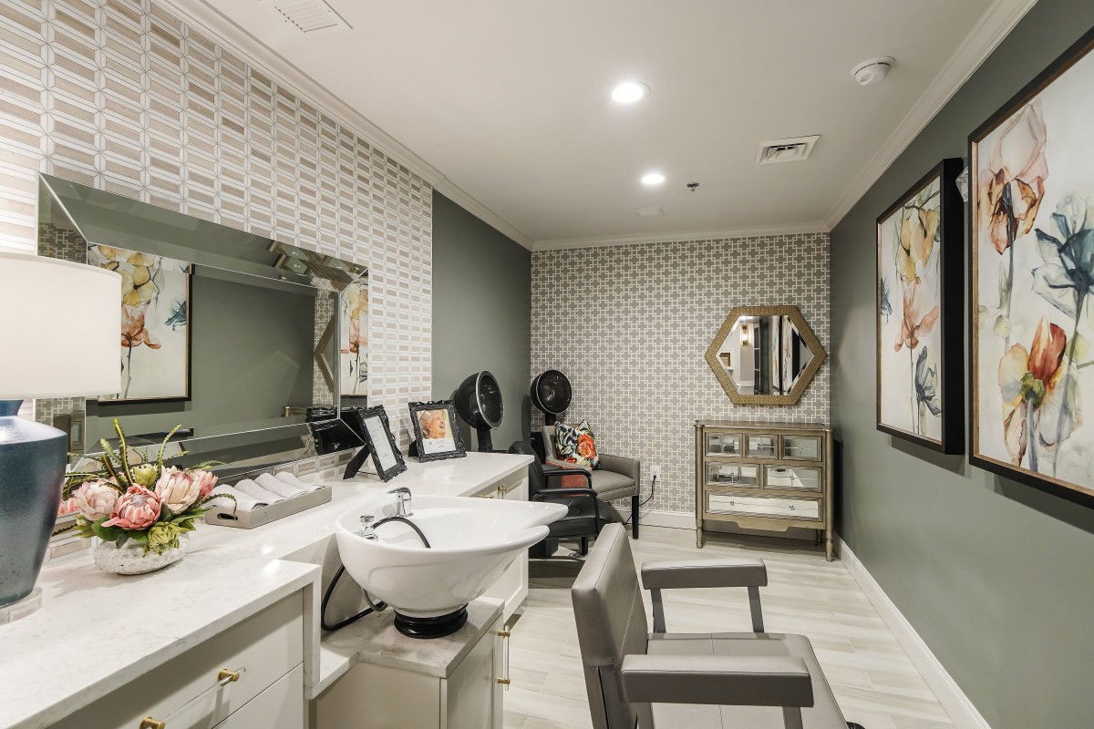 A modern salon interior featuring a hair washing station and stylish decor.