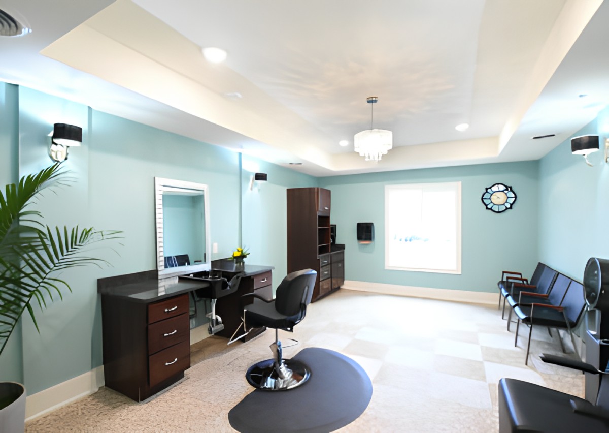 A modern salon interior with stylish furniture and ample lighting.