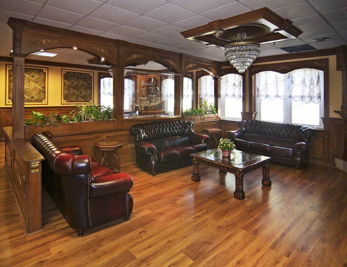 Elegant lobby with leather sofas and a central chandelier.