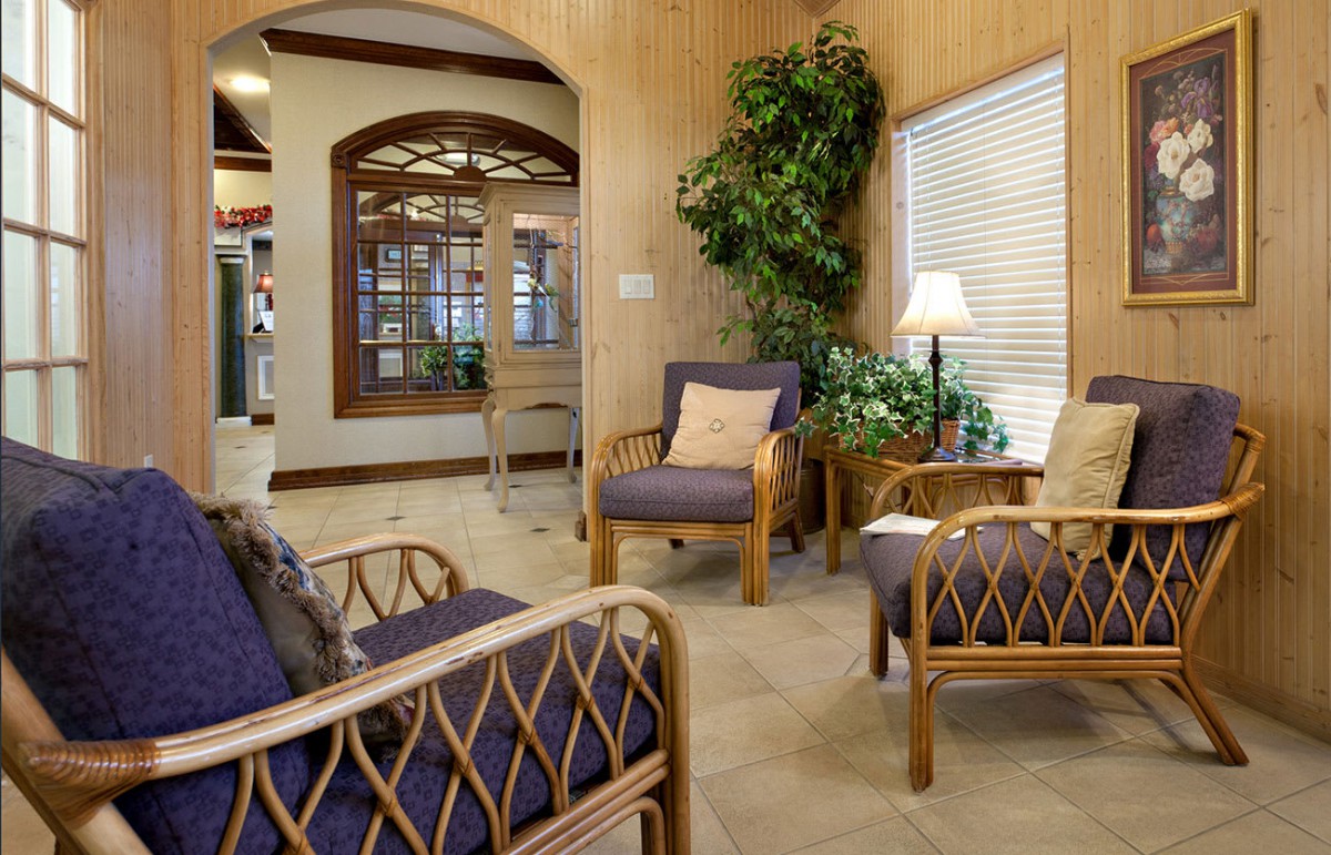 A cozy waiting room with comfortable seating and indoor plants.