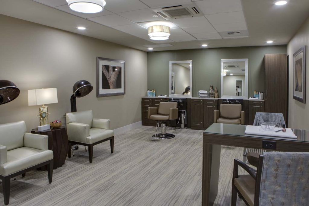 A modern hair salon interior with stylish furniture and equipment.