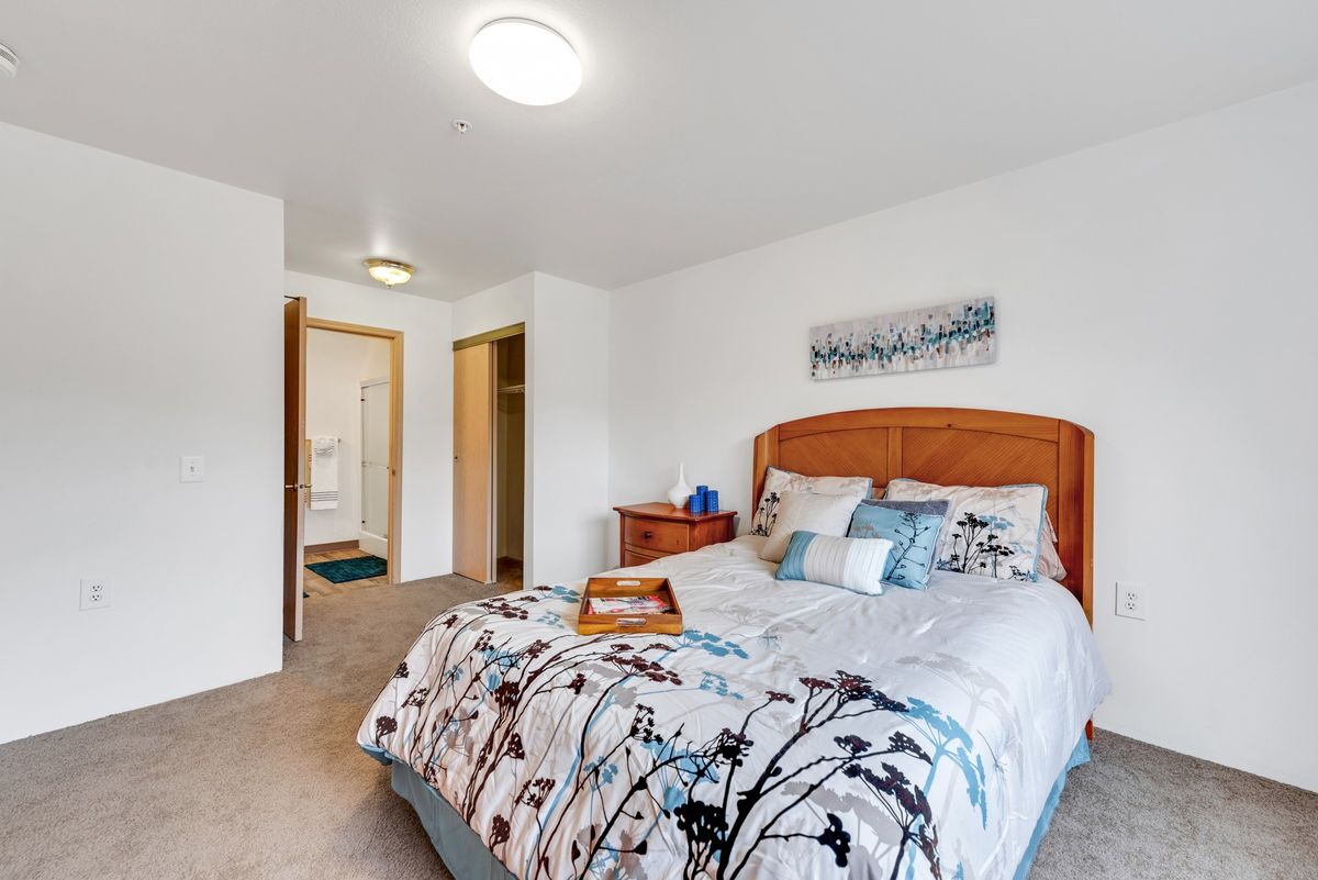 A cozy bedroom with neatly arranged bedding and tasteful decor.