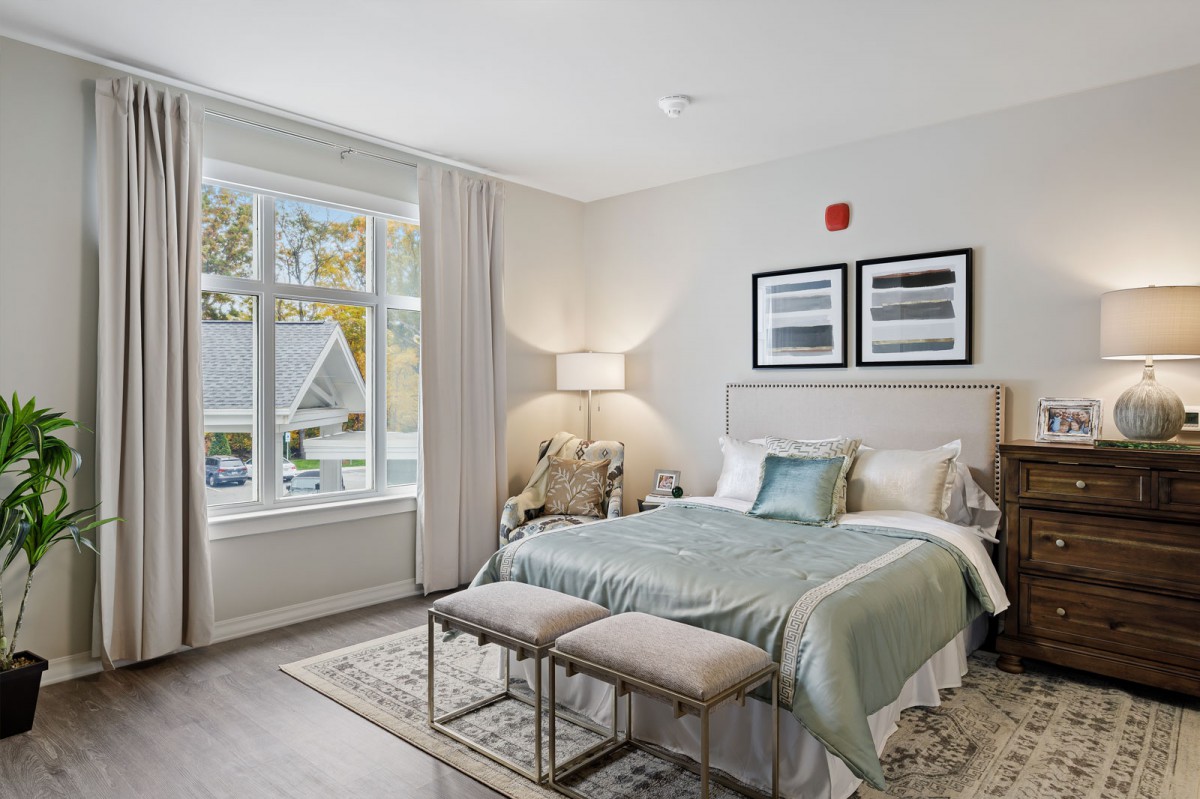 A modern bedroom with large windows and elegant decor.