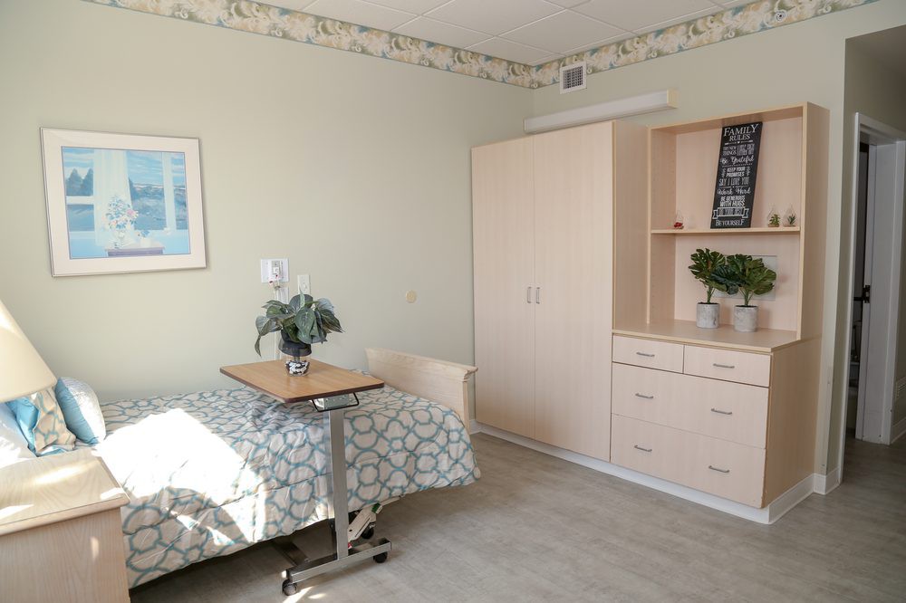 A simple, well-lit room with a hospital bed and minimalist decor.
