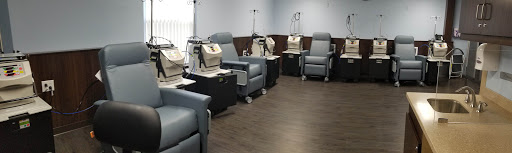A clean and organized medical treatment area featuring comfortable chairs for patients undergoing procedures.