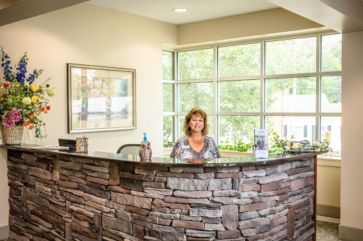 A welcoming reception area with a woman at the front desk.