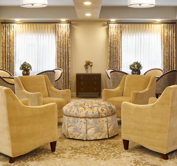 Elegant living room with arranged seating and warm lighting.