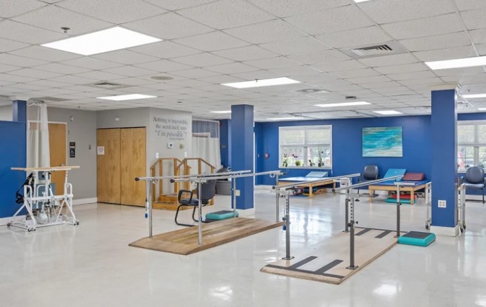 A therapy room equipped with rehabilitation and exercise equipment.