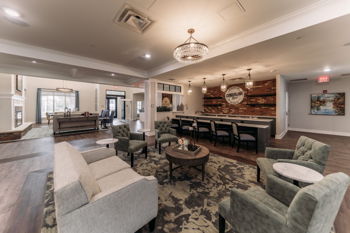 A modern living room with comfortable seating and a stylish bar area.