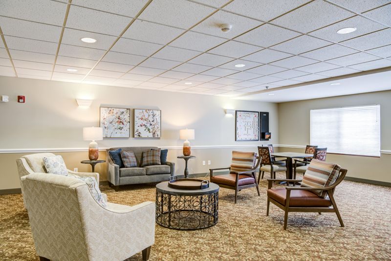 A cozy living room with a comfortable seating arrangement and soft lighting.