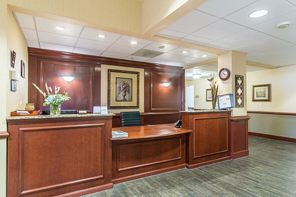 Elegant wooden reception desk in an office setting.