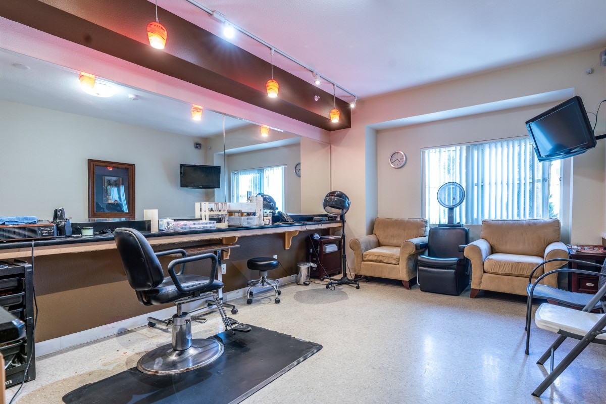 A modern salon interior with barber chairs and mirrors.