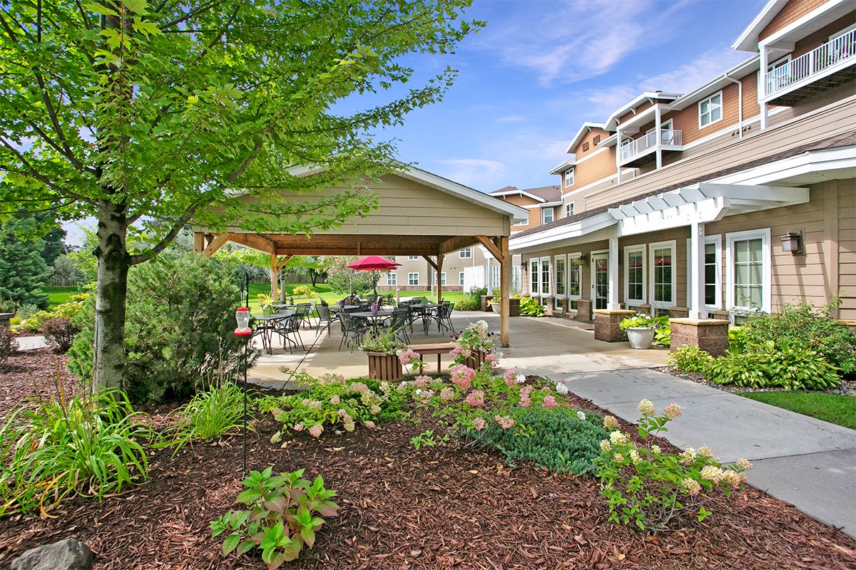 A peaceful garden patio area with outdoor seating and lush landscaping.
