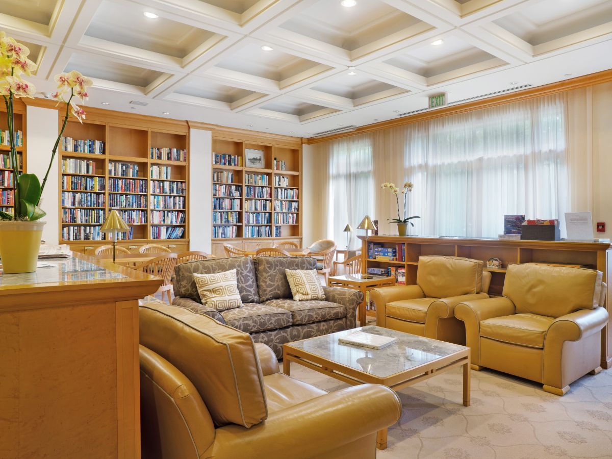 A cozy library space with comfortable seating and bookshelves filled with books.