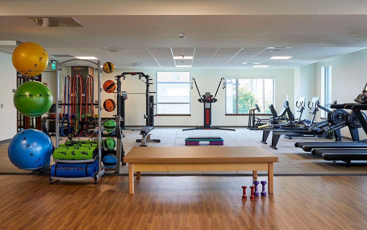 A well-equipped gym with various exercise machines, weights, and fitness accessories.