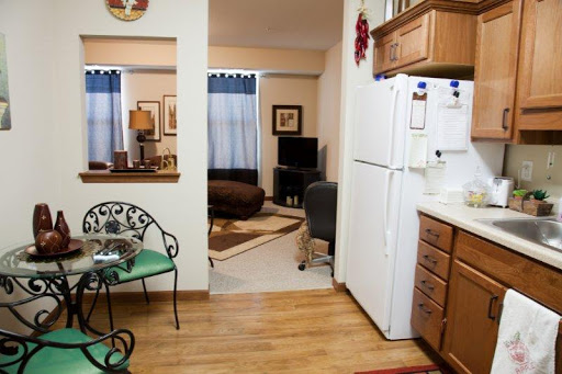A cozy view of an apartment showcasing a connected kitchen and living area.