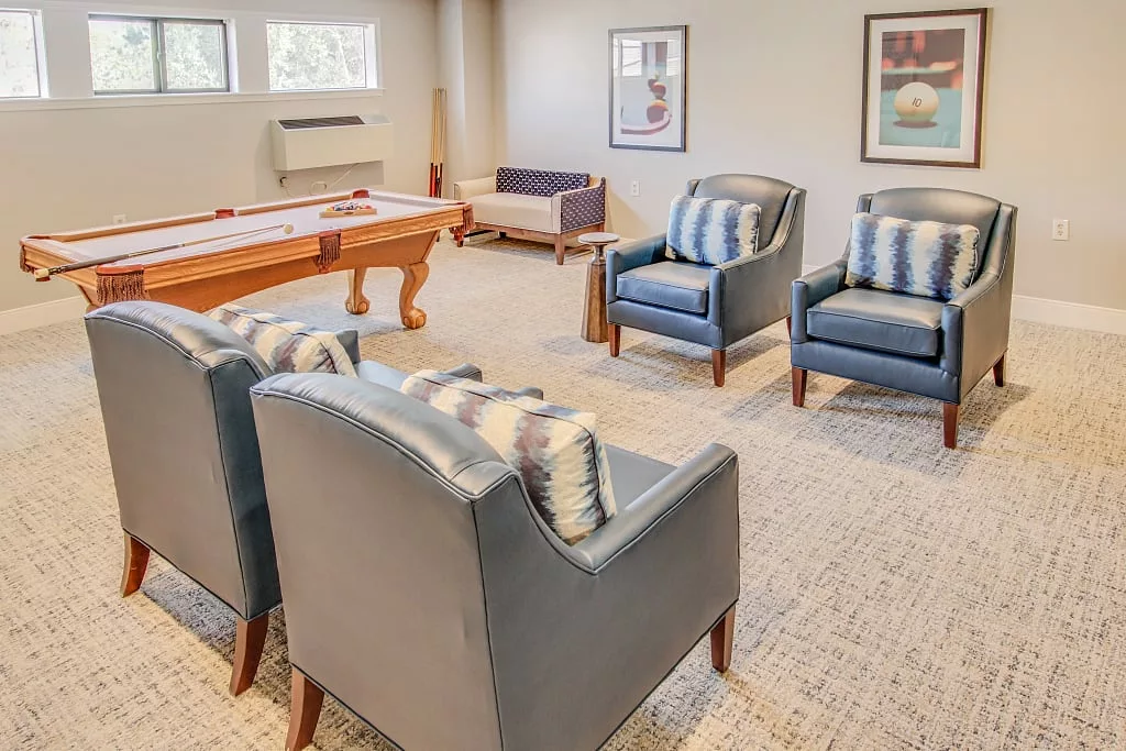 A cozy living area featuring comfortable seating and a pool table.