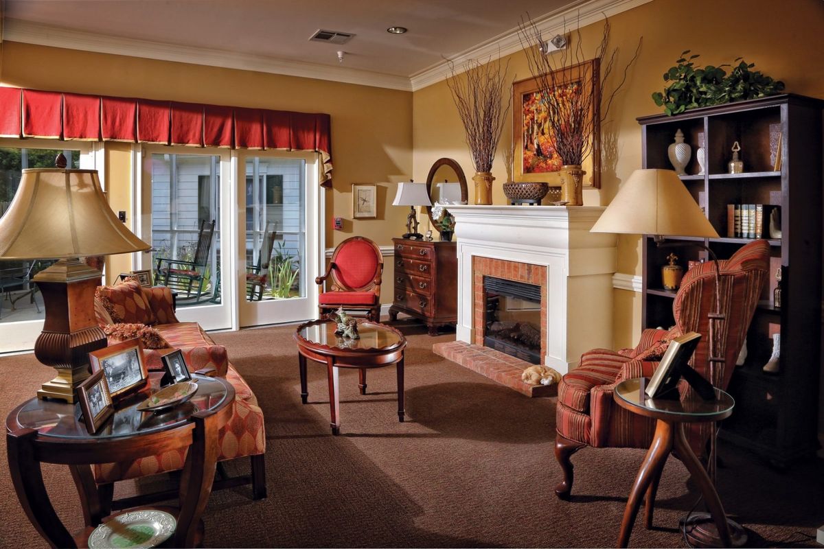 A cozy and traditionally styled living room featuring a fireplace, comfortable seating, and elegant decor.