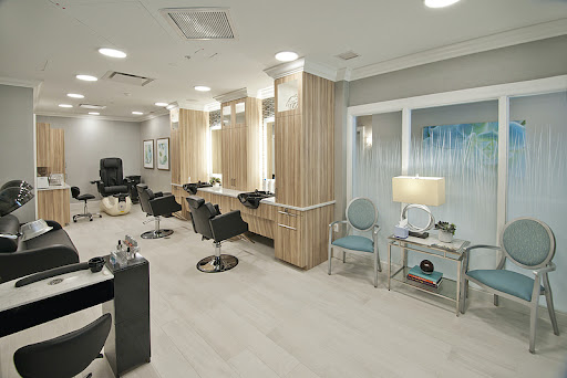 A modern hair salon featuring elegant chairs and well-designed lighting.
