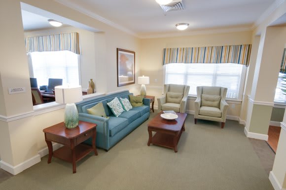 A cozy living room with comfortable seating and warm lighting.