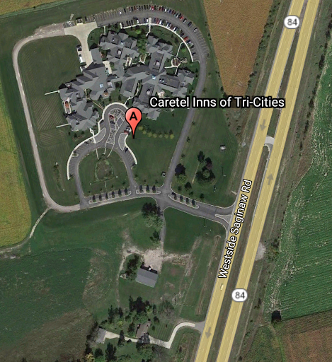 Aerial view of a residential property situated near a major highway.